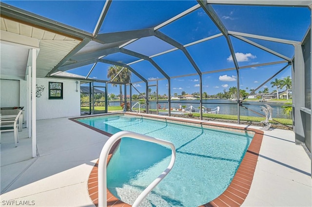 view of swimming pool with glass enclosure, a water view, and a patio