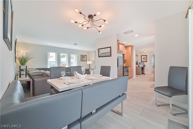 living room featuring light hardwood / wood-style floors and an inviting chandelier