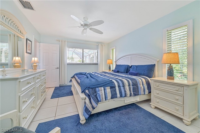 bedroom with ceiling fan and light tile patterned flooring