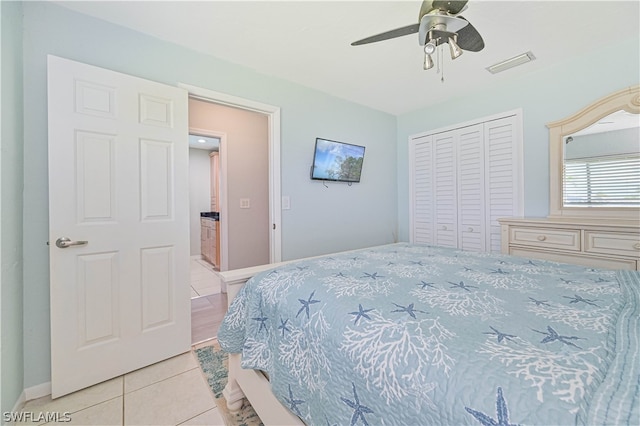 tiled bedroom with a closet and ceiling fan