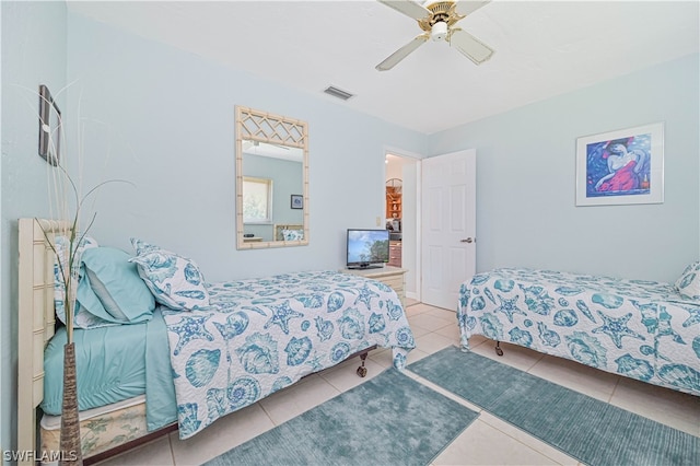 tiled bedroom featuring ceiling fan