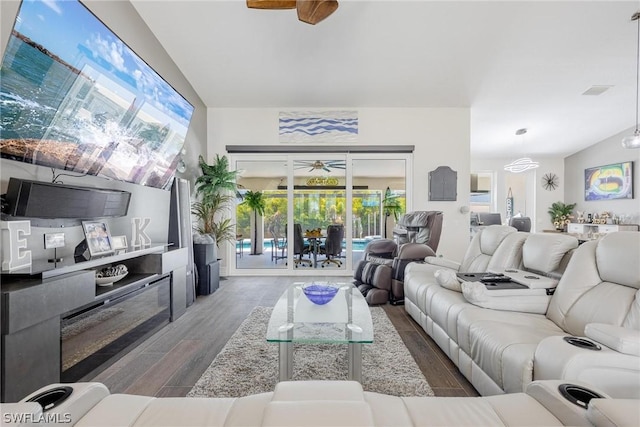 living room with dark hardwood / wood-style floors, a wealth of natural light, and ceiling fan