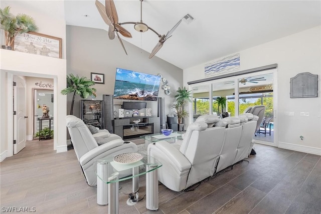 living room with ceiling fan, hardwood / wood-style floors, and high vaulted ceiling