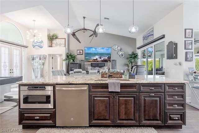 kitchen featuring light hardwood / wood-style floors, sink, lofted ceiling, and hanging light fixtures