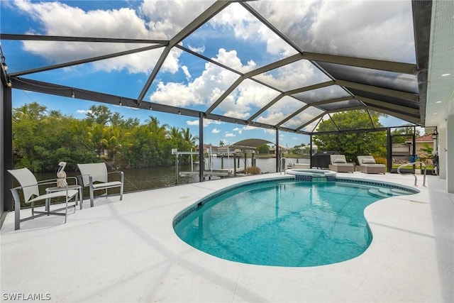 view of swimming pool with glass enclosure, a water view, a patio, and a dock