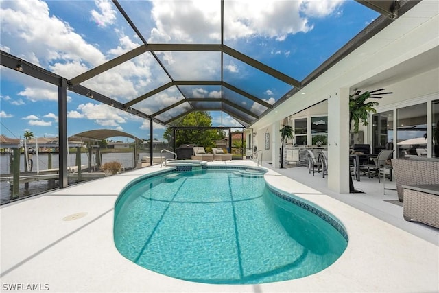 view of pool featuring a lanai, a water view, and a patio