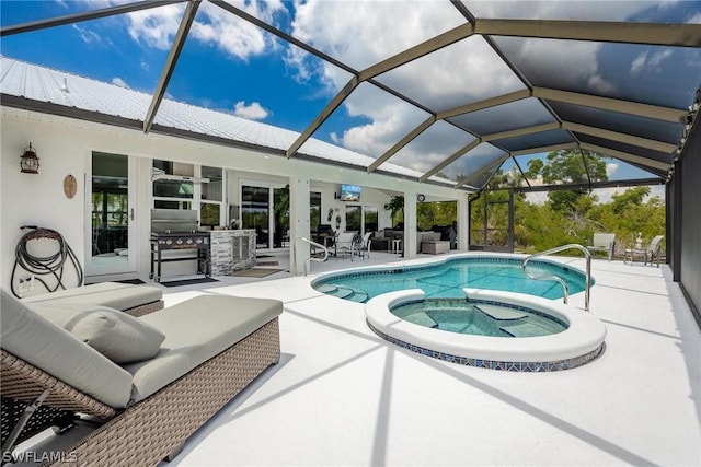 view of swimming pool with an in ground hot tub, an outdoor kitchen, an outdoor hangout area, glass enclosure, and a patio area