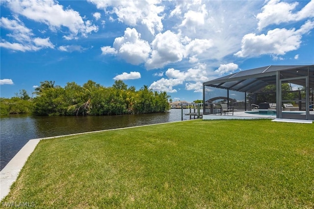 dock area with a water view, a lanai, and a lawn