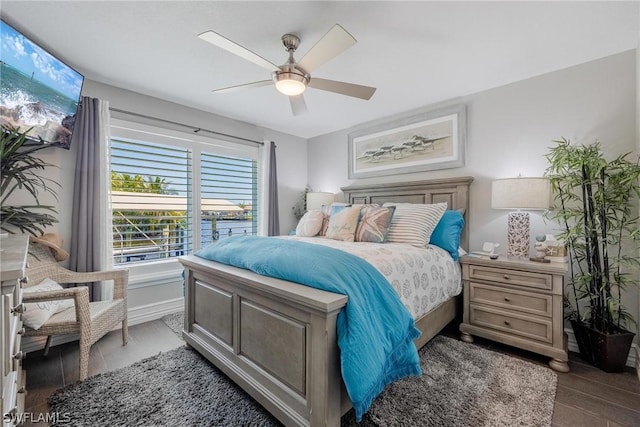 bedroom with ceiling fan and dark hardwood / wood-style flooring