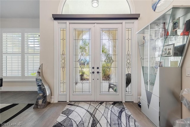 doorway to outside with french doors and wood-type flooring