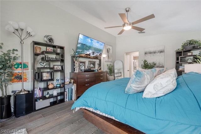 bedroom with hardwood / wood-style flooring, ceiling fan, and lofted ceiling