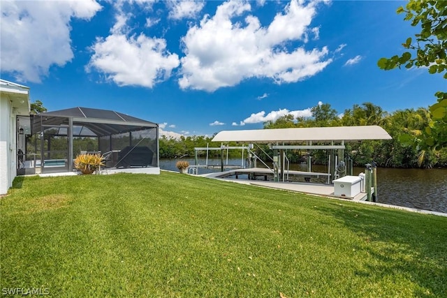 dock area with glass enclosure, a yard, and a water view