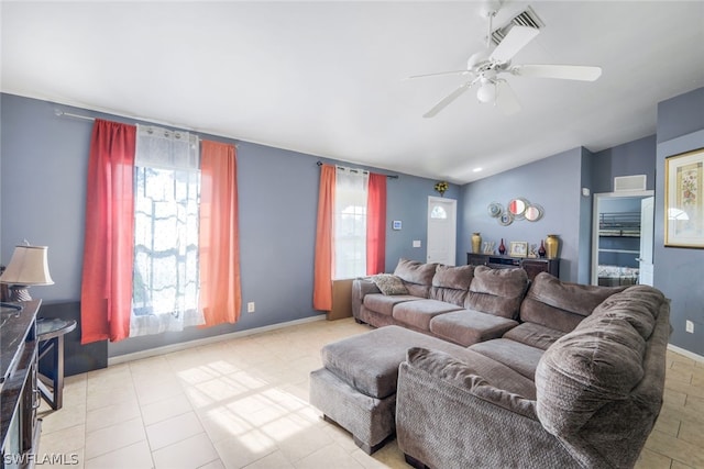 tiled living room featuring ceiling fan