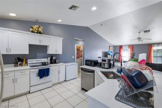 kitchen with electric range, ceiling fan, vaulted ceiling, and stainless steel dishwasher