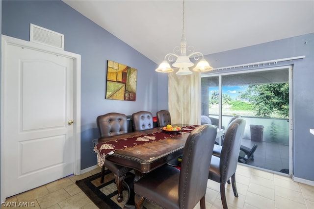 tiled dining space featuring a chandelier and lofted ceiling