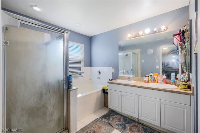 bathroom with tile floors, dual vanity, and independent shower and bath