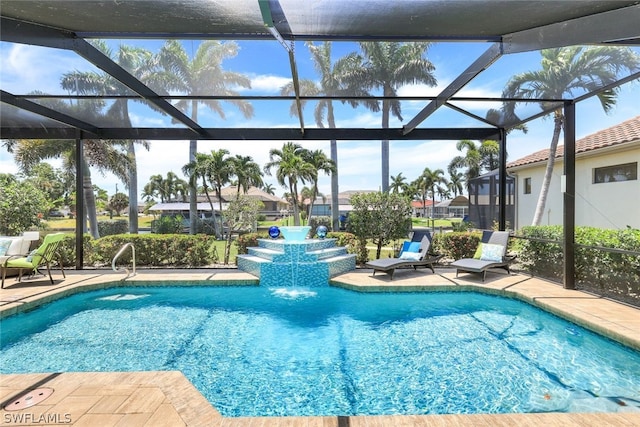 view of swimming pool featuring glass enclosure, pool water feature, and a patio area