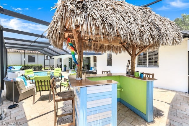 view of terrace featuring glass enclosure, a bar, and a pool