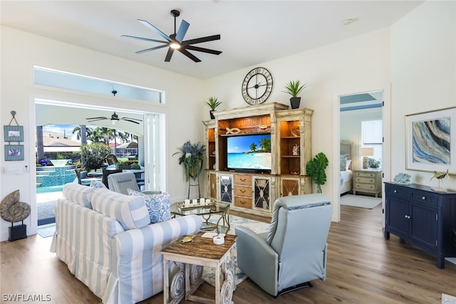 living room featuring a healthy amount of sunlight, wood-type flooring, and ceiling fan