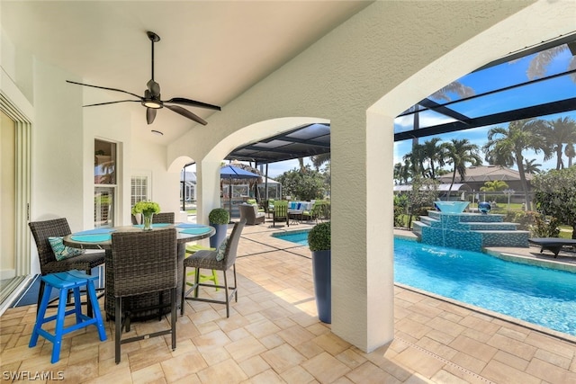 view of patio / terrace with pool water feature, a lanai, and ceiling fan