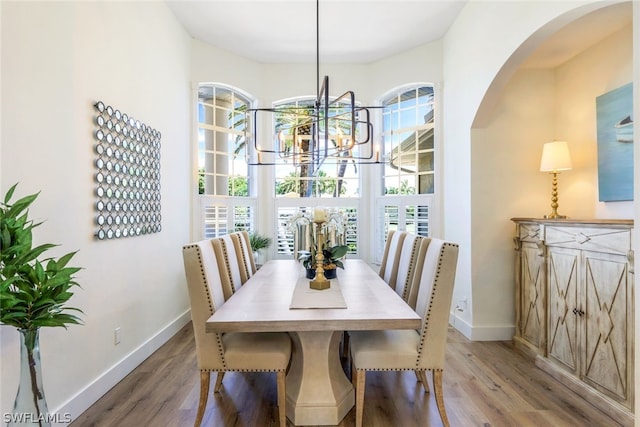 dining space with a chandelier and hardwood / wood-style flooring