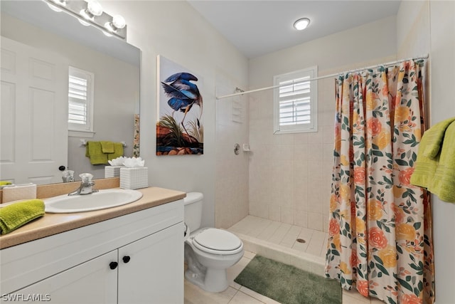 bathroom with tile floors, walk in shower, toilet, and large vanity