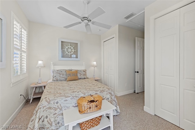 bedroom featuring light carpet, ceiling fan, and multiple windows