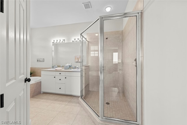 bathroom with tile floors, separate shower and tub, and dual bowl vanity