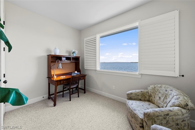 office space with carpet and a water view