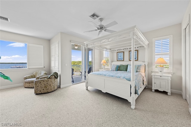 bedroom with a water view, ceiling fan, carpet floors, and access to outside