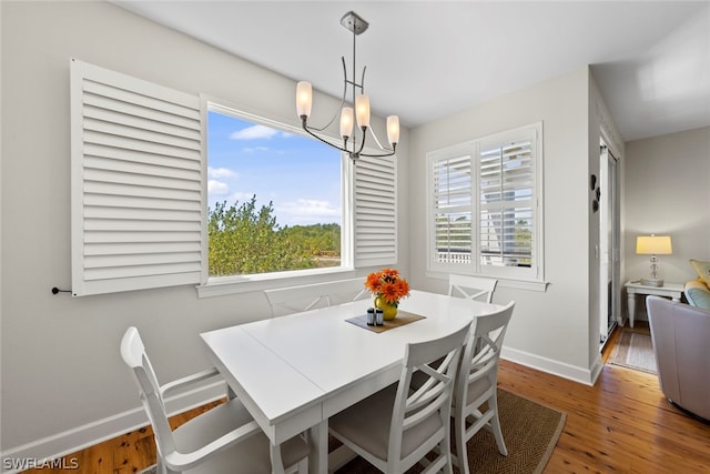 dining space featuring a chandelier and hardwood / wood-style flooring