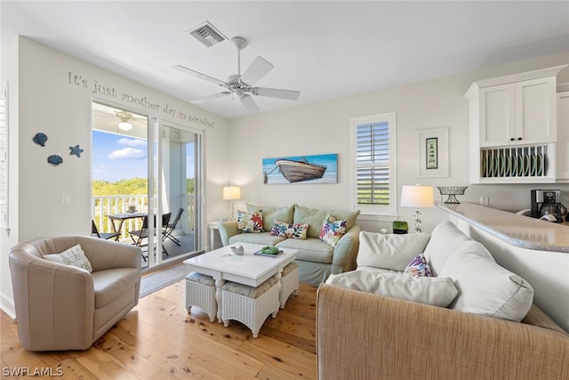 living room with ceiling fan and light wood-type flooring