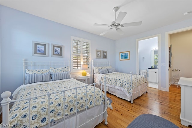 bedroom with ceiling fan, connected bathroom, and light hardwood / wood-style flooring