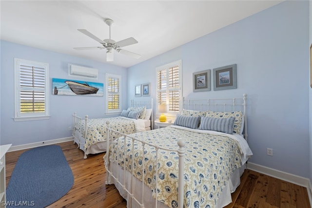 bedroom with hardwood / wood-style floors, ceiling fan, and an AC wall unit