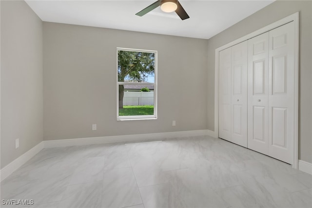 unfurnished bedroom featuring a closet and ceiling fan