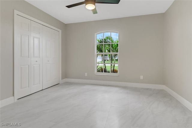 unfurnished bedroom featuring a closet and ceiling fan