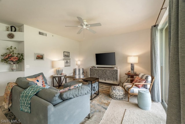 carpeted living room with ceiling fan