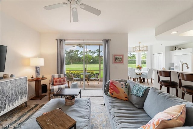 living room featuring a wealth of natural light and ceiling fan