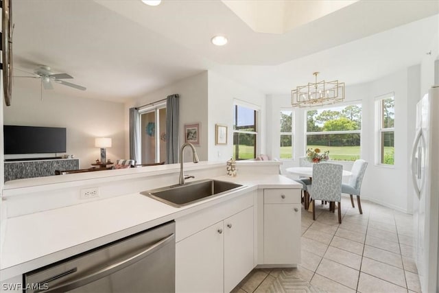 kitchen with white cabinetry, sink, hanging light fixtures, white fridge, and stainless steel dishwasher