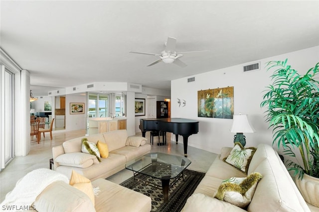 living room featuring a healthy amount of sunlight, ceiling fan, and light tile flooring