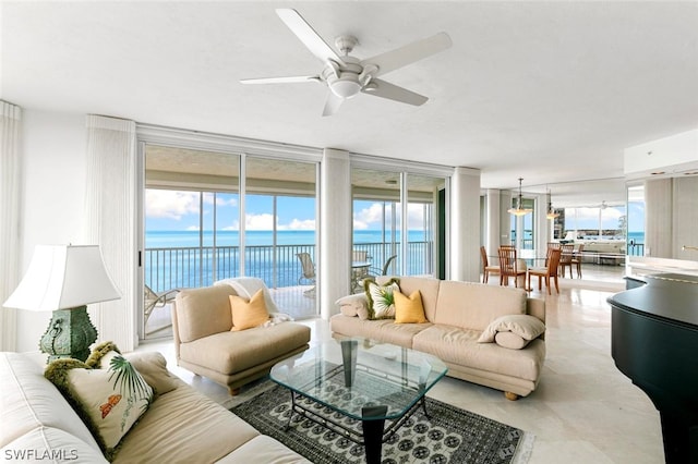 living room with expansive windows, a water view, plenty of natural light, and ceiling fan