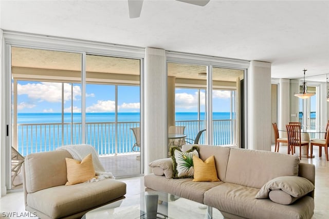 living room with floor to ceiling windows and a water view