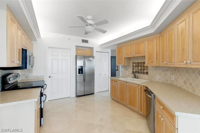 kitchen with sink, ornamental molding, ceiling fan, stainless steel appliances, and backsplash