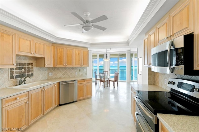 kitchen with light brown cabinetry, sink, crown molding, pendant lighting, and stainless steel appliances