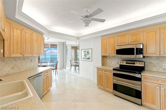 kitchen with sink, decorative backsplash, stainless steel appliances, crown molding, and light brown cabinets