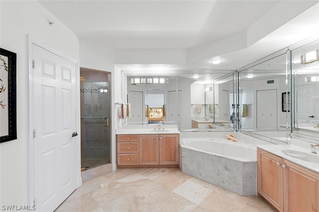 bathroom featuring vanity and shower with separate bathtub