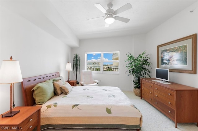 bedroom with ceiling fan and light carpet