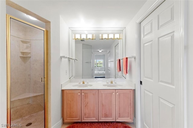 bathroom with vanity with extensive cabinet space, double sink, and an enclosed shower