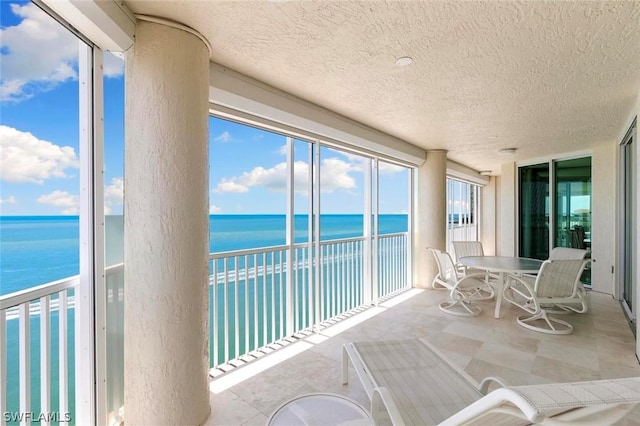 sunroom / solarium with a water view