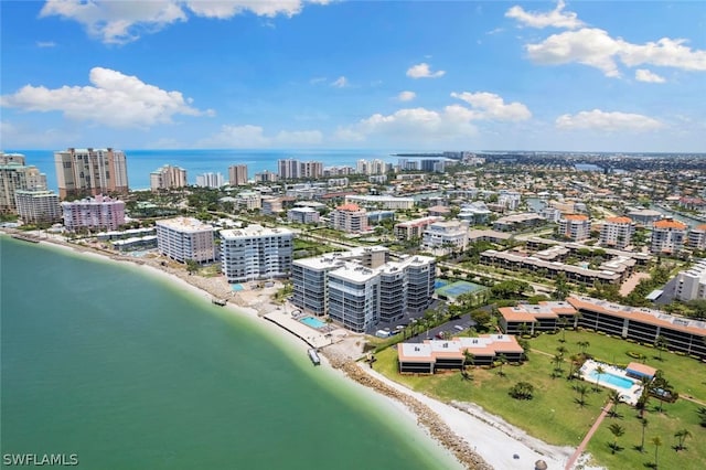 birds eye view of property with a water view and a view of the beach